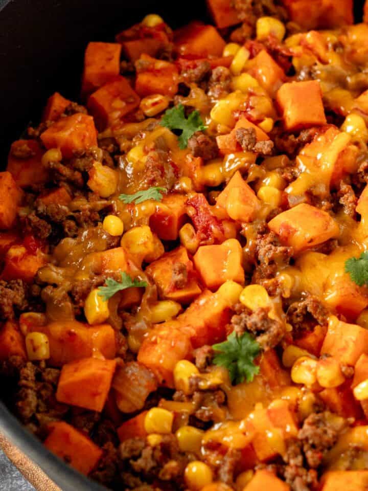 ground beef and sweet potatoes in skillet with cheese.