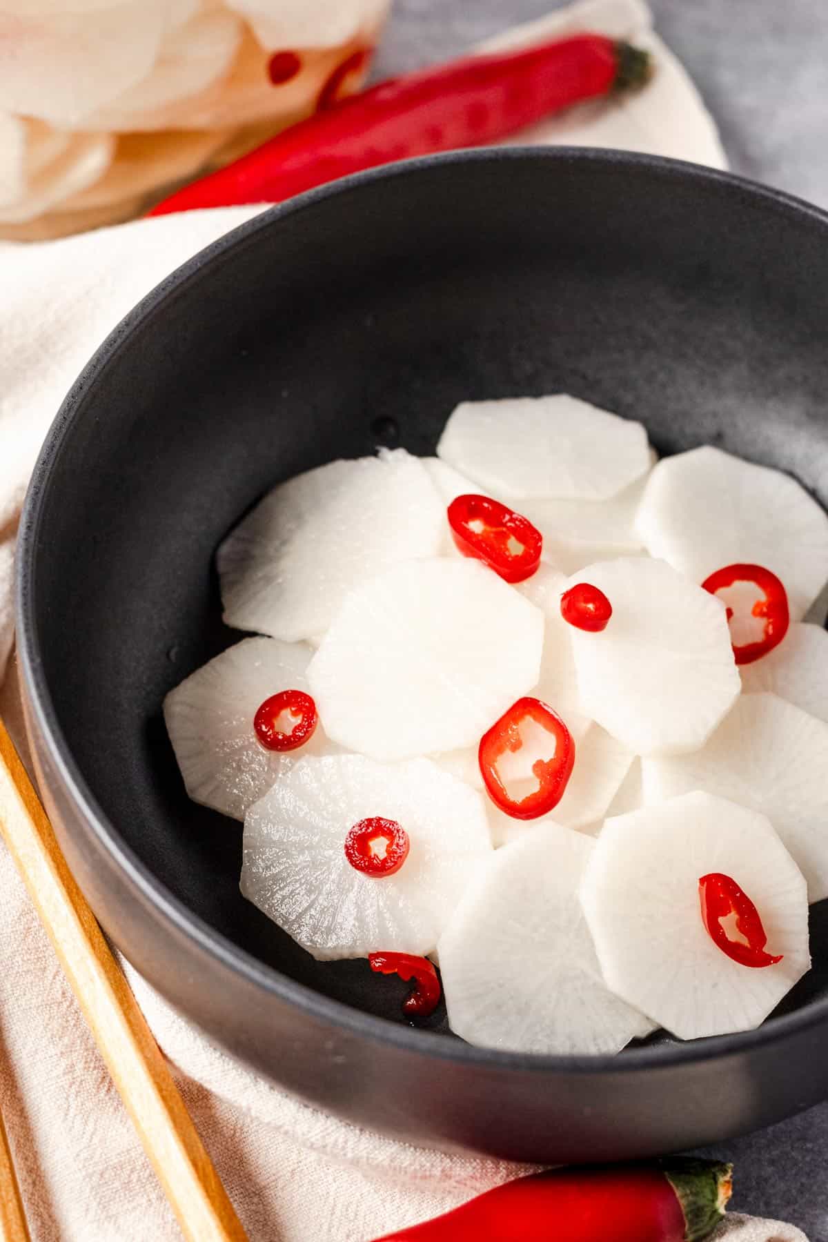 a bowl of pickled daikon with red chili