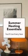Modern indoor table with a portable fan, table lamp, and framed wall art, highlighting practical essentials that can help make summer hosting more comfortable.