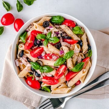 A simple and savory cold pasta salad made with just a few ingredients like tuna, olives, tomatoes, gluten free pasta and an easy salad dressing. Can be served hot or cold to fit any season!