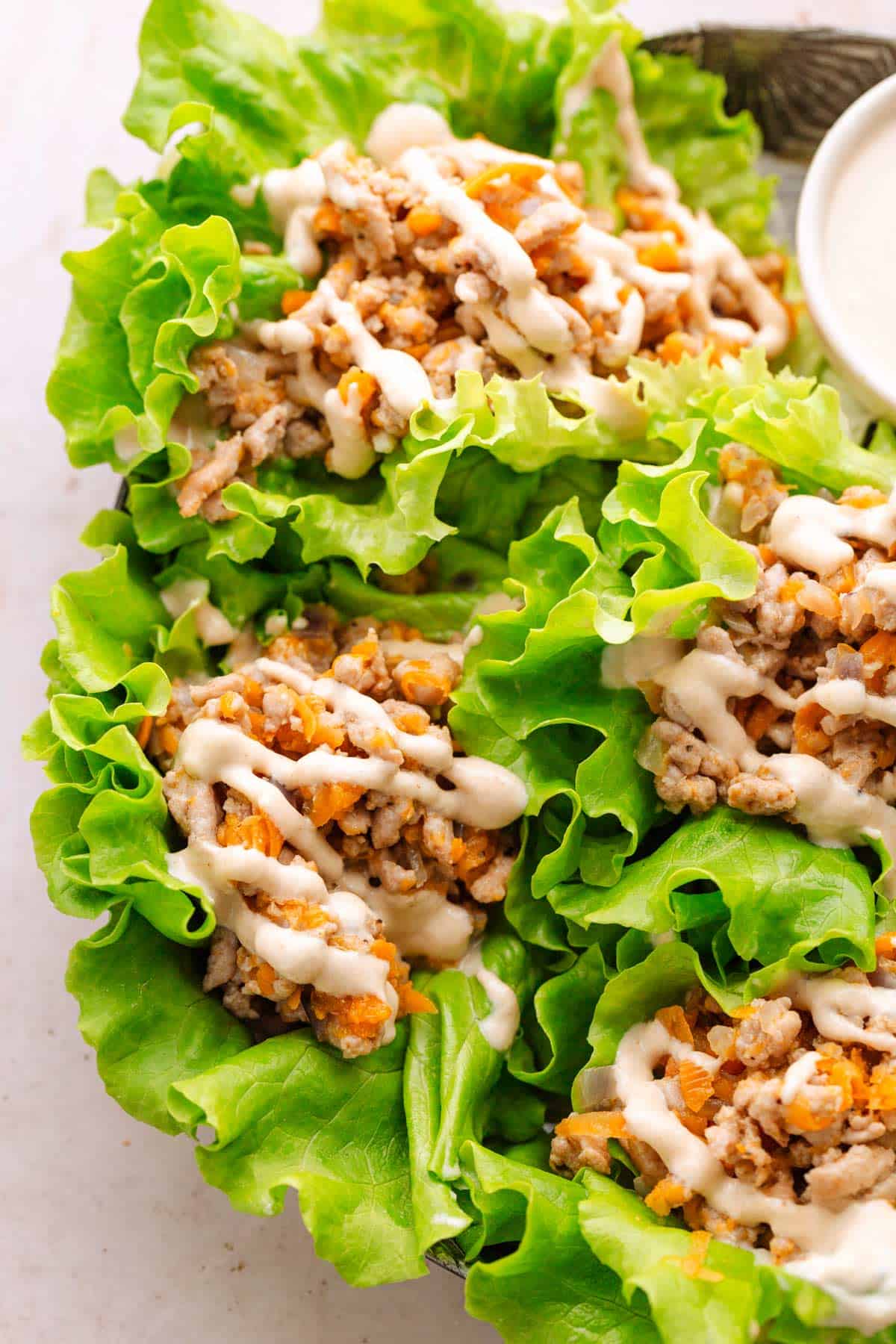 Ground turkey wraps with tahini sauce.