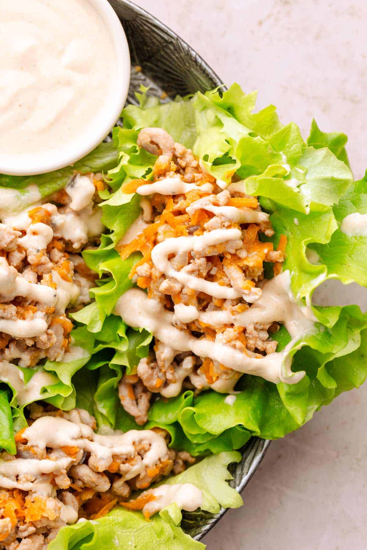 Ground turkey wraps with tahini sauce.