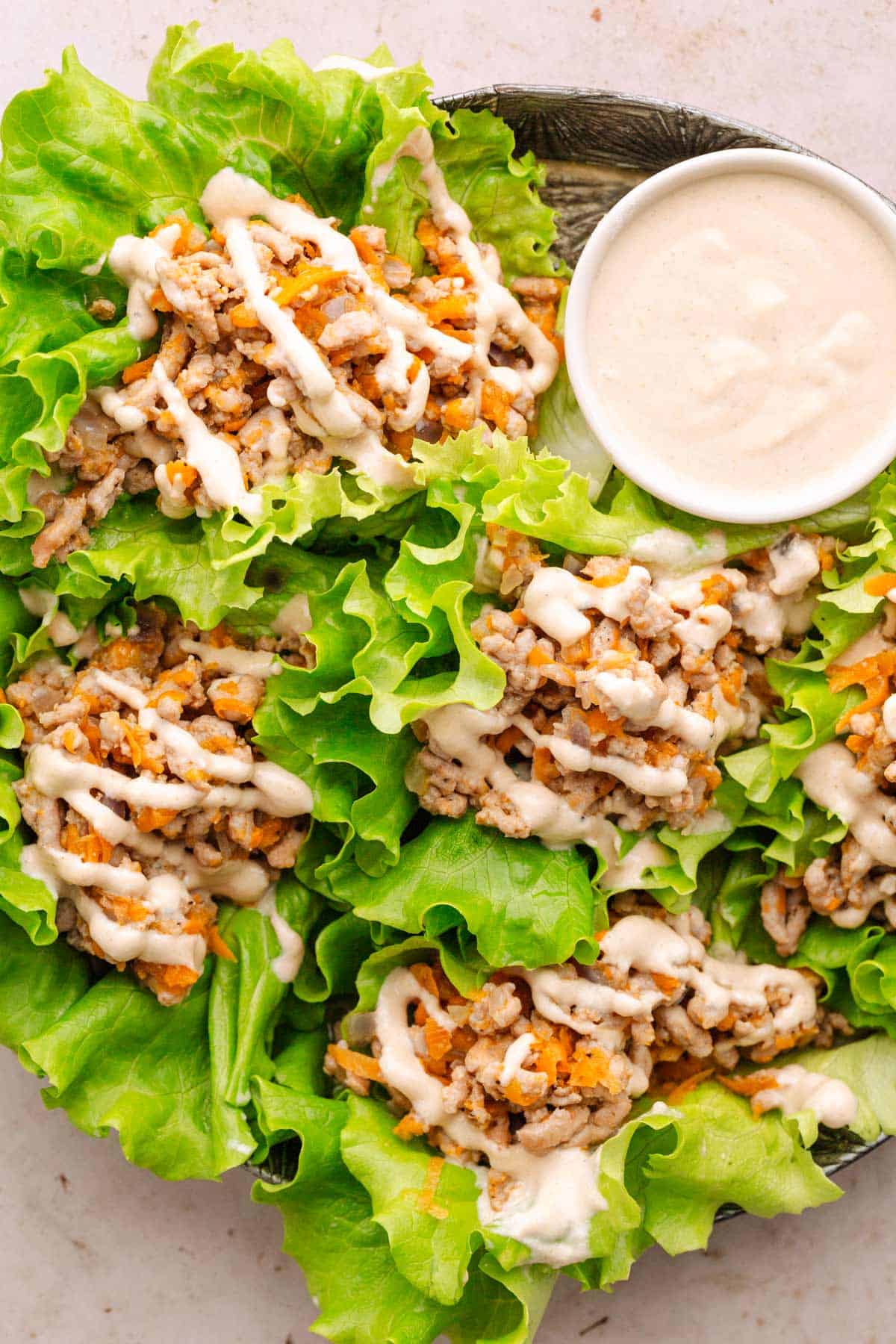 Ground turkey wraps with tahini sauce.