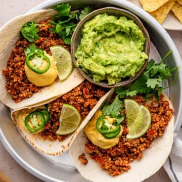 lentil tacos served with cashew queso cheese and guacamole.