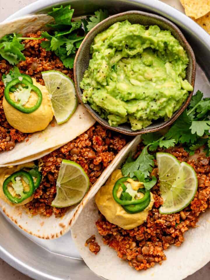 lentil tacos served with cashew queso cheese and guacamole.