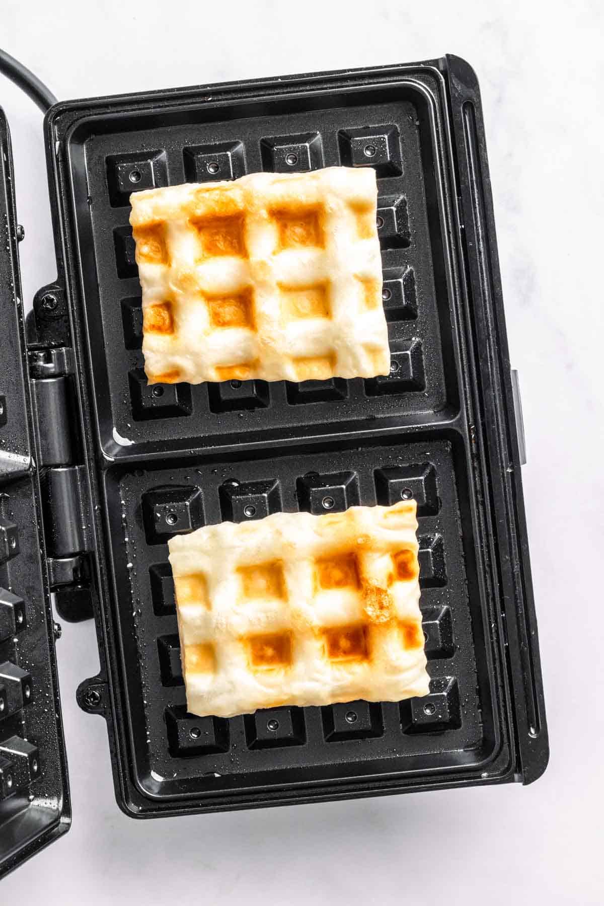 Puff pastry waffles in waffle maker.