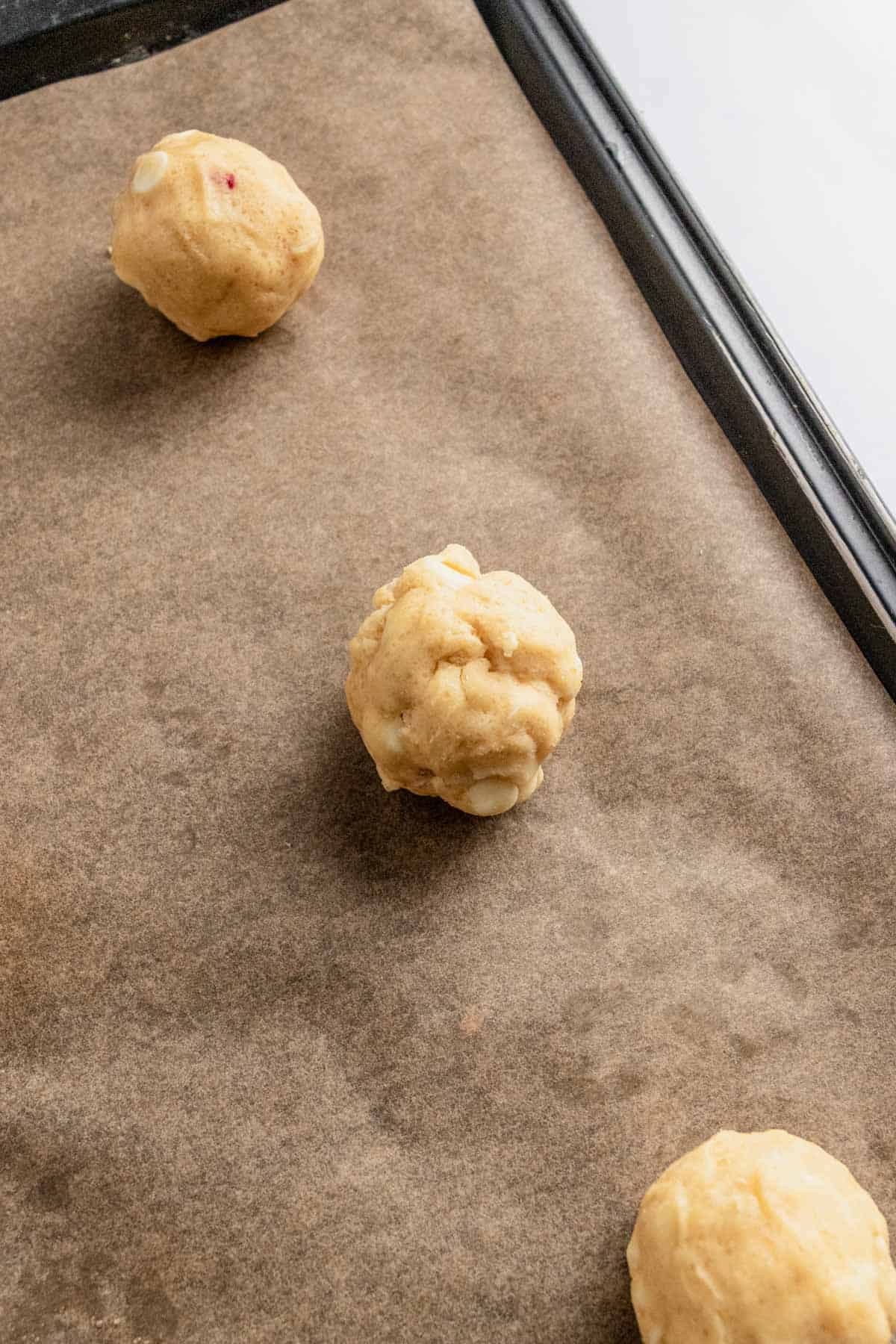 macadamia nut cookie dough balls on baking sheet
