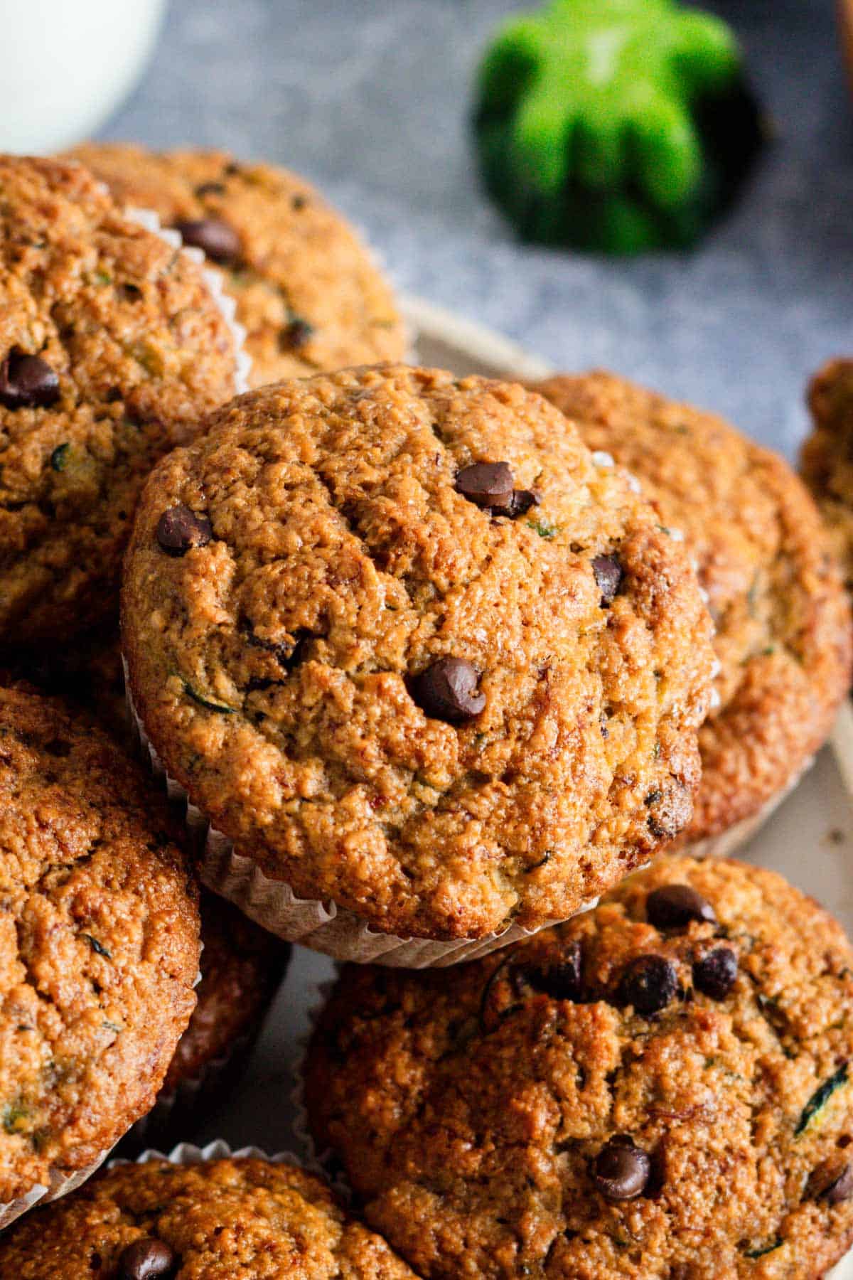 a bunch of gluten free zucchini muffins on a round wire rack.