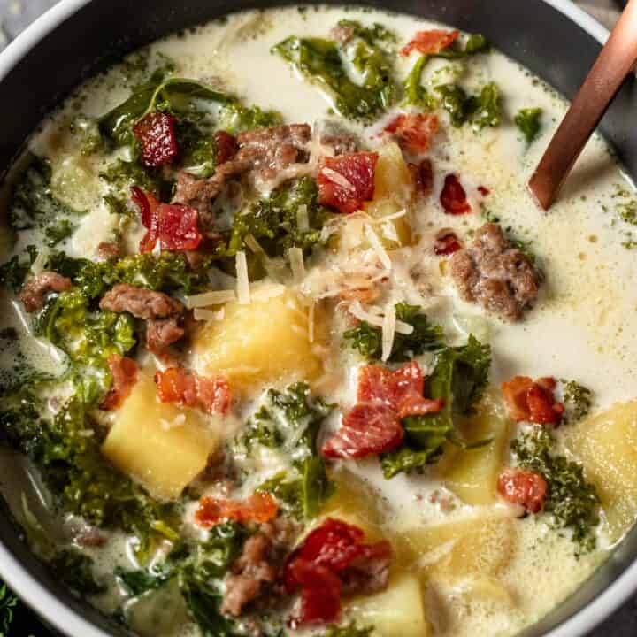 creamy kale sausage and potato soup in a bowl.